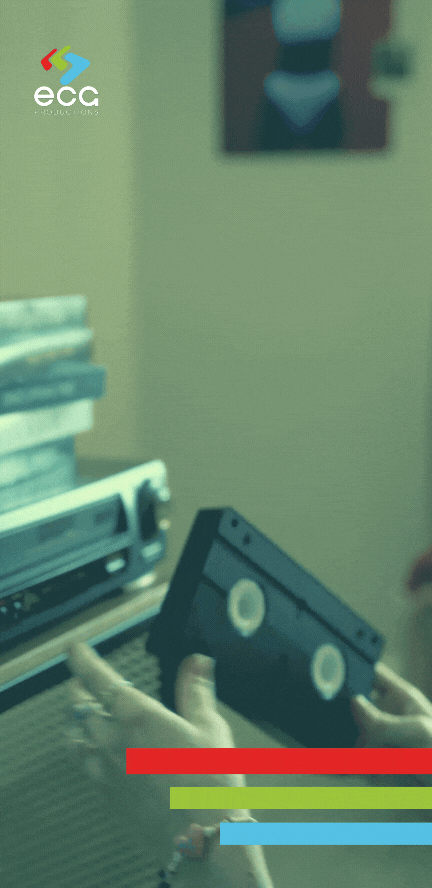 A medium shot of a VHS tape being loaded into a VCR, representing the starting point for media restoration and digitization.