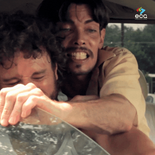 Two men sit in a van, arguing and fighting over the window, showcasing the power of narrative scriptwriting in developing engaging character-driven conflict.