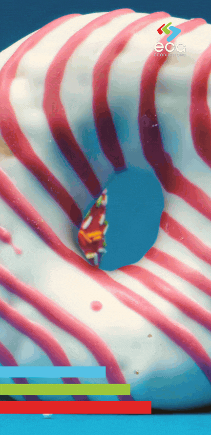 A close-up of a striped donut on a bright background, highlighting the precision of video color grading & color correction in commercial and product videography.