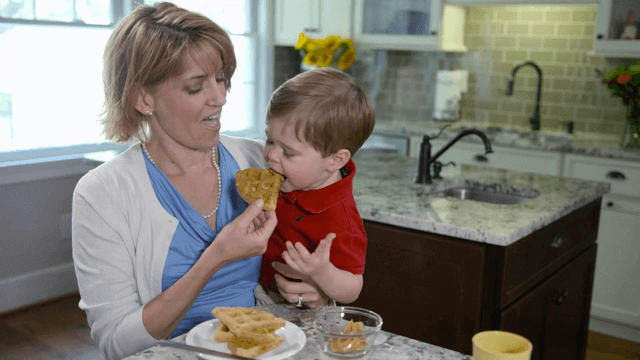 Child and mother eating peanut butter waffles