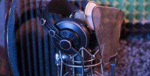 headphones and microphone inside a recording booth at a studio