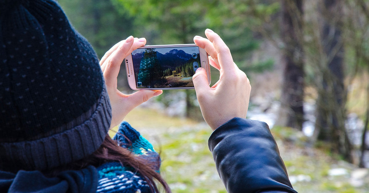 Woman taking a VR tour with her phone.