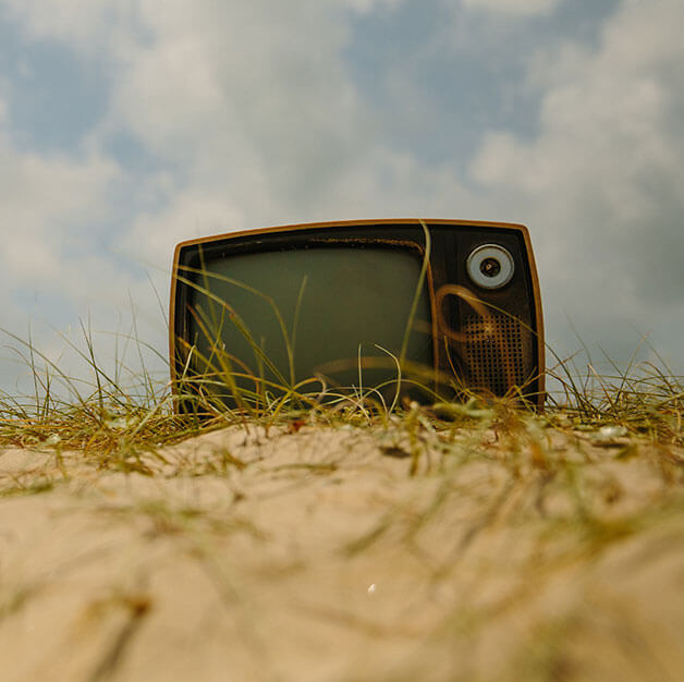 Older model TV on the beach