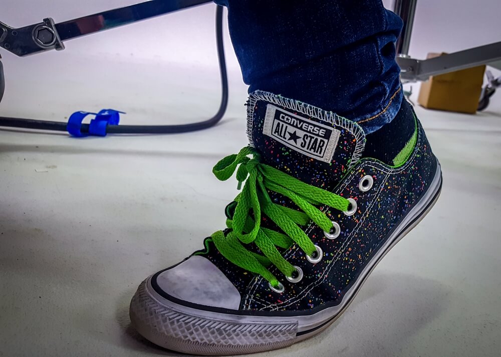 Jenn wearing Converse All Star shoes on set.