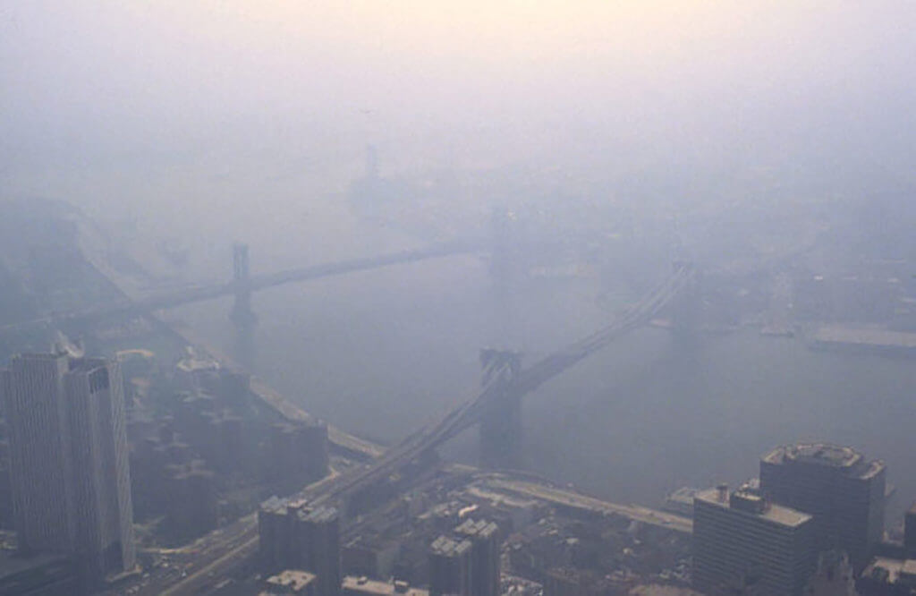 Grayish aerial view of NYC while smog diffuses the light