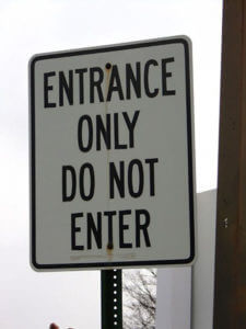 A confusing street sign says, "Entrance only. Do not enter."