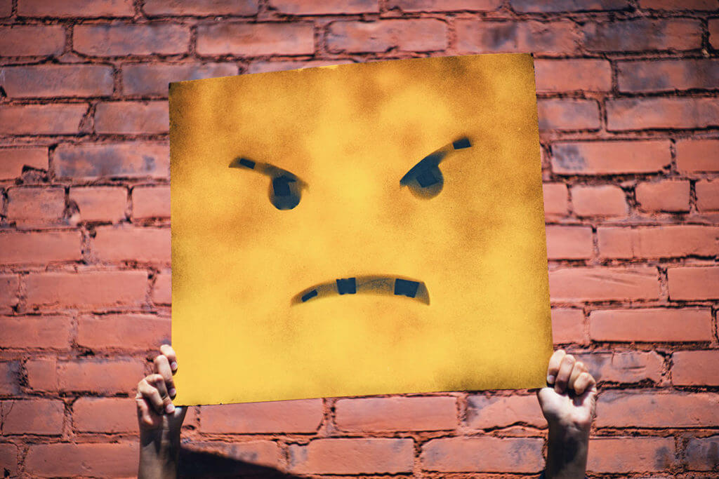 An angry face on a poster, symbolic of what post-production feels like after hearing the one thing they never want to hear.