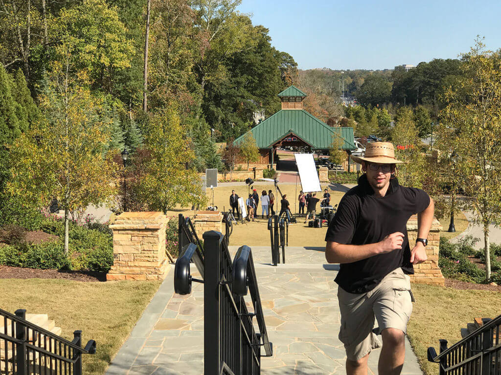 Brandon Peterson, behind the scenes, runs back up the main stairs to prepare for the 2018 demo reel.