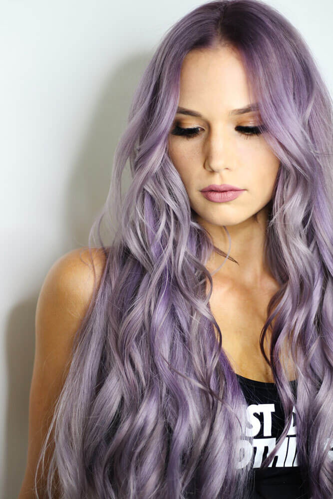 A woman with long purple hair who went to a colorist.