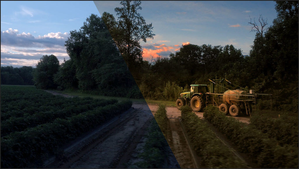 A farm tractor on a road with half of the image color graded and half not color graded.