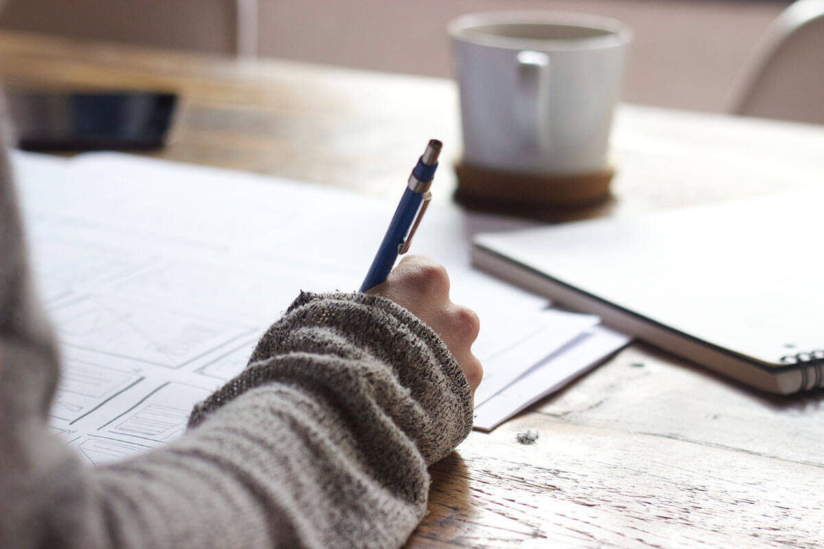Creatively focused person writing.