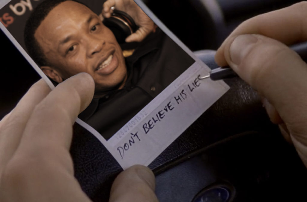 Dr. Dre with Beats Headphones inside of a Polaroid picture reminiscent of the movie "Momento." At the bottom, someone is writing "Don't believe his lies."