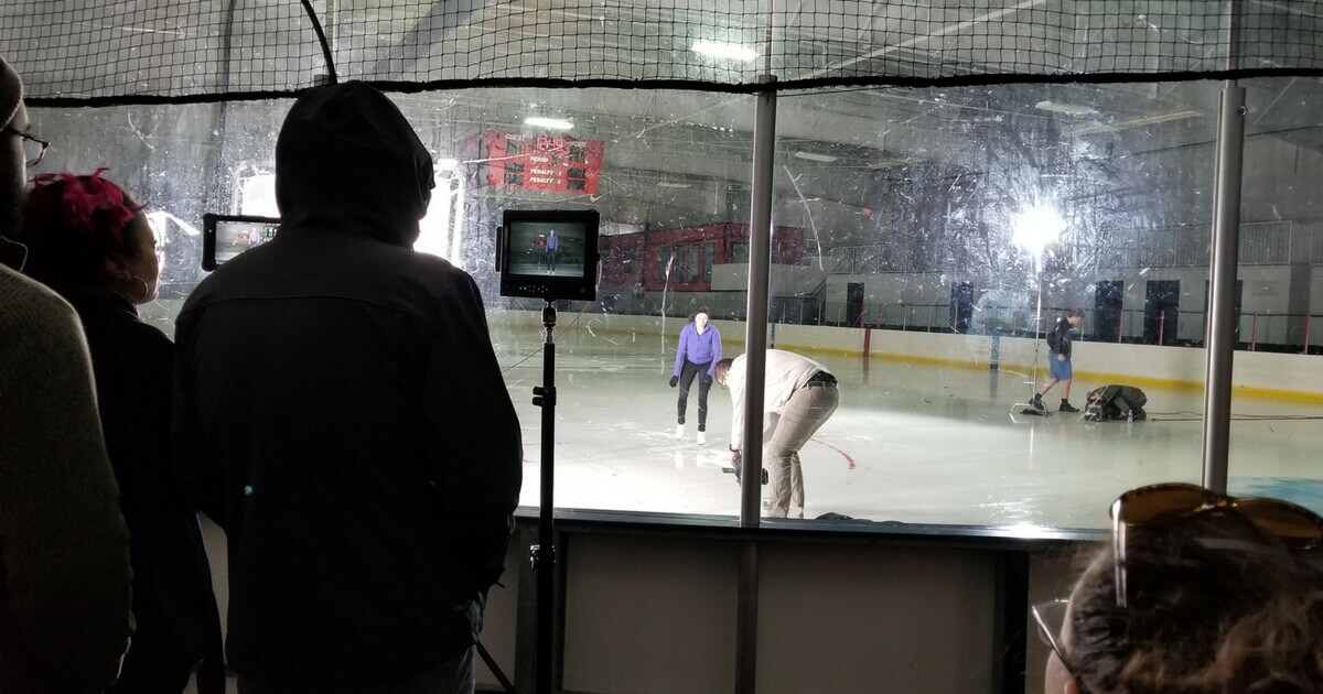 Medical TV commercial production filming in an ice rink.