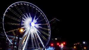A ferris wheel shines bright against a night sky, symbolizing the importance of engineering in Georgia.