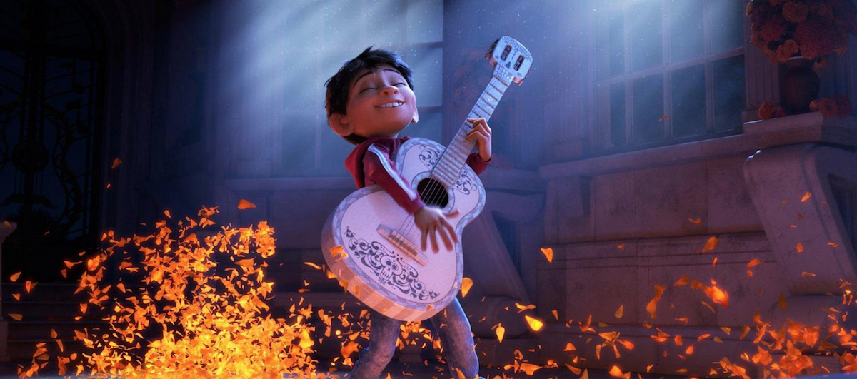 Miguel plays "De la Cruz" with his guitar.