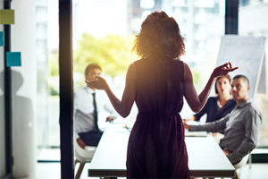 A female entrepreneur handling business like a woman during a presentation.