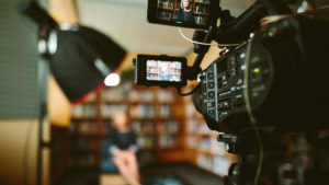 A woman gets a location on a budget by recording in a library.