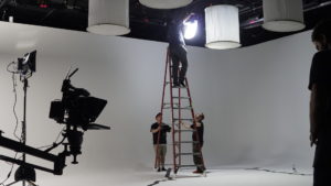 A team of film and TV grips work to pre-light a studio in Atlanta, GA