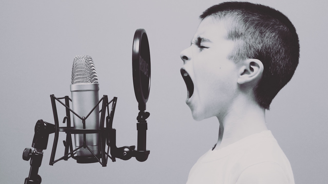 A kid screaming into a microphone during a voiceover.