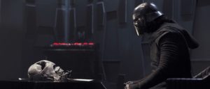 Kylo Ren stares at Darth vader's helmet.