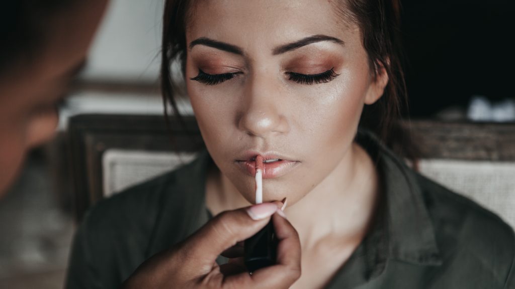 Makeup artist applies make up