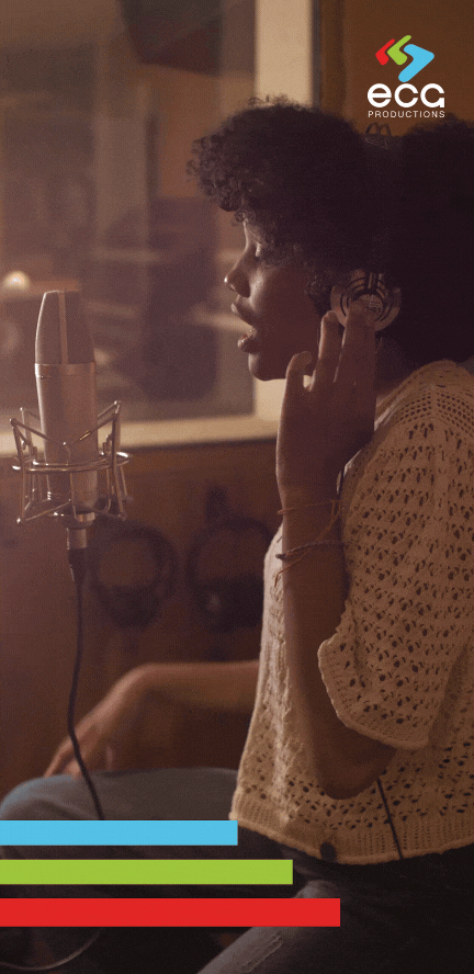 A Black woman records a voiceover in a professional studio, showcasing the skill and precision of voiceover artists in delivering high-quality narration