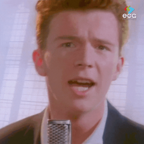 Close-up of a young man singing passionately into a retro microphone—capturing the iconic opening of the viral video central to the history of the Rick Roll.