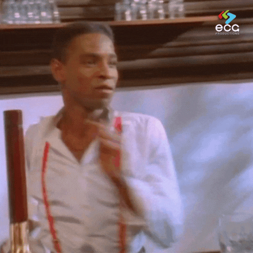 Bartender in red suspenders breaking into a joyful dance behind the bar—one of the many unexpected and memorable scenes from the music video that sparked the history of the Rick Roll.