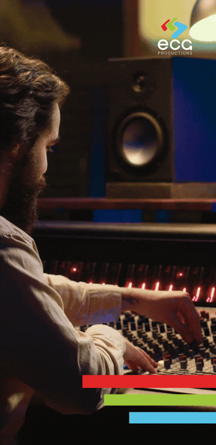 A White producer with a beard, working on an audio mixing board during an ADR session, fine-tuning dialogue replacement for seamless integration in post-production.