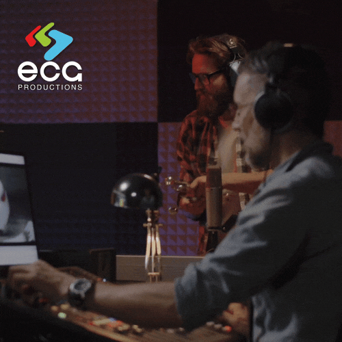 Foley artists bang wrenches together in a professional studio, creating realistic sound effects that enhance on-screen action in film and television.