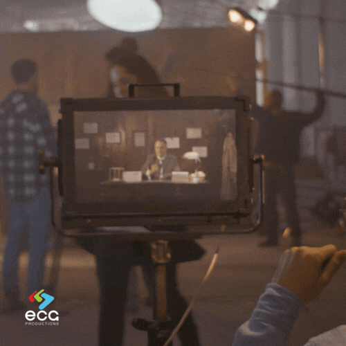 Wide shot of a film set in production, capturing the full crew in action, including audio personnel equipped with boom mics and mixers, highlighting the collaborative efforts of the audio department in achieving seamless sound on set.