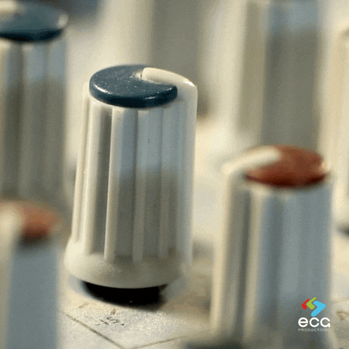 Extreme close-up of knobs on a mixing board, showcasing the fine-tuned control and precision the audio department applies to sound mixing.
