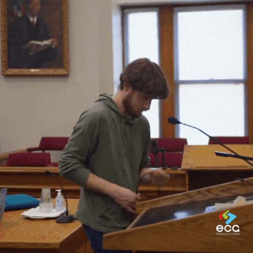 A Production Coordinator oversees the pre-lighting of a courtroom set, exemplifying the role’s focus on preparation and on-set organization.