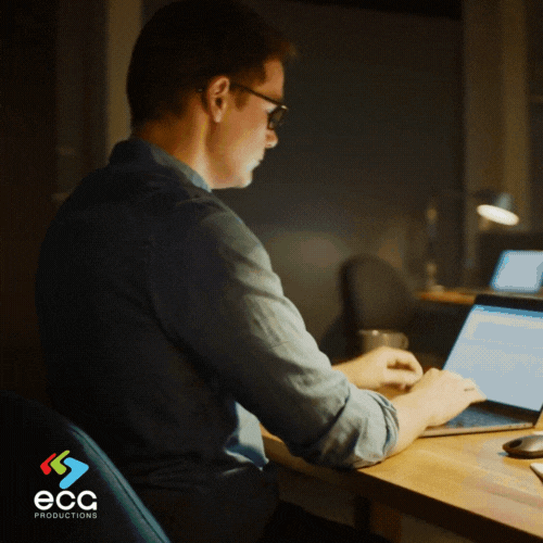 A line producer works in his office, preparing a detailed spreadsheet of production budgets, demonstrating the organizational expertise required for effective line producing.