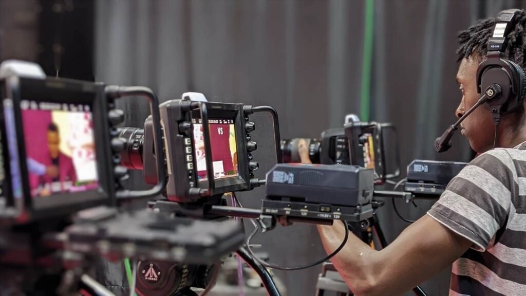 A black man gets trained on in studio video cameras