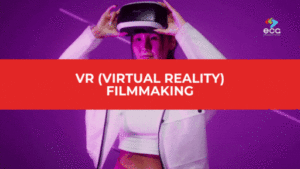 Woman in a futuristic white outfit putting on a VR headset under neon purple lighting, with a red banner that reads “VR (Virtual Reality) Filmmaking”—capturing the cutting-edge energy and immersive potential of VR filmmaking.