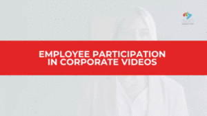 Professional woman fades into view on screen with a confident expression, overlaid by a bold red banner reading “Employee Participation in Corporate Videos”—emphasizing the value of real voices and authentic storytelling in company media.