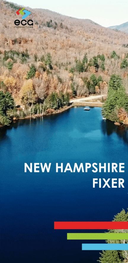 Aerial shot over a serene pond surrounded by dense forest, gradually rising to reveal a breathtaking view of the New Hampshire mountains in the morning light. This peaceful, natural setting is a prime location a 'New Hampshire fixer' might arrange for film and TV projects, capturing the untouched beauty of the region's landscapes and coordinating logistics to showcase the majestic transition from water to mountain scenery.