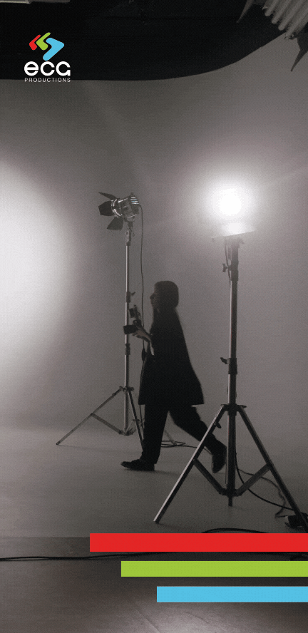 A woman walks across the floor of Studio A at ECG Productions, showcasing the spacious and versatile video production studio equipped for a variety of creative projects.