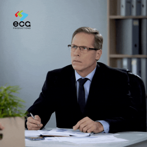 Corporate executive in a suit attentively listening and nodding during a meeting—illustrating how employee participation in corporate videos enhances professionalism, credibility, and human connection in company communications.