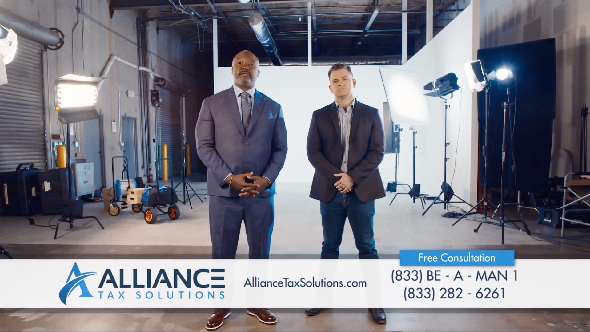Two men from Alliance Tax Solutions break through the fourth wall.