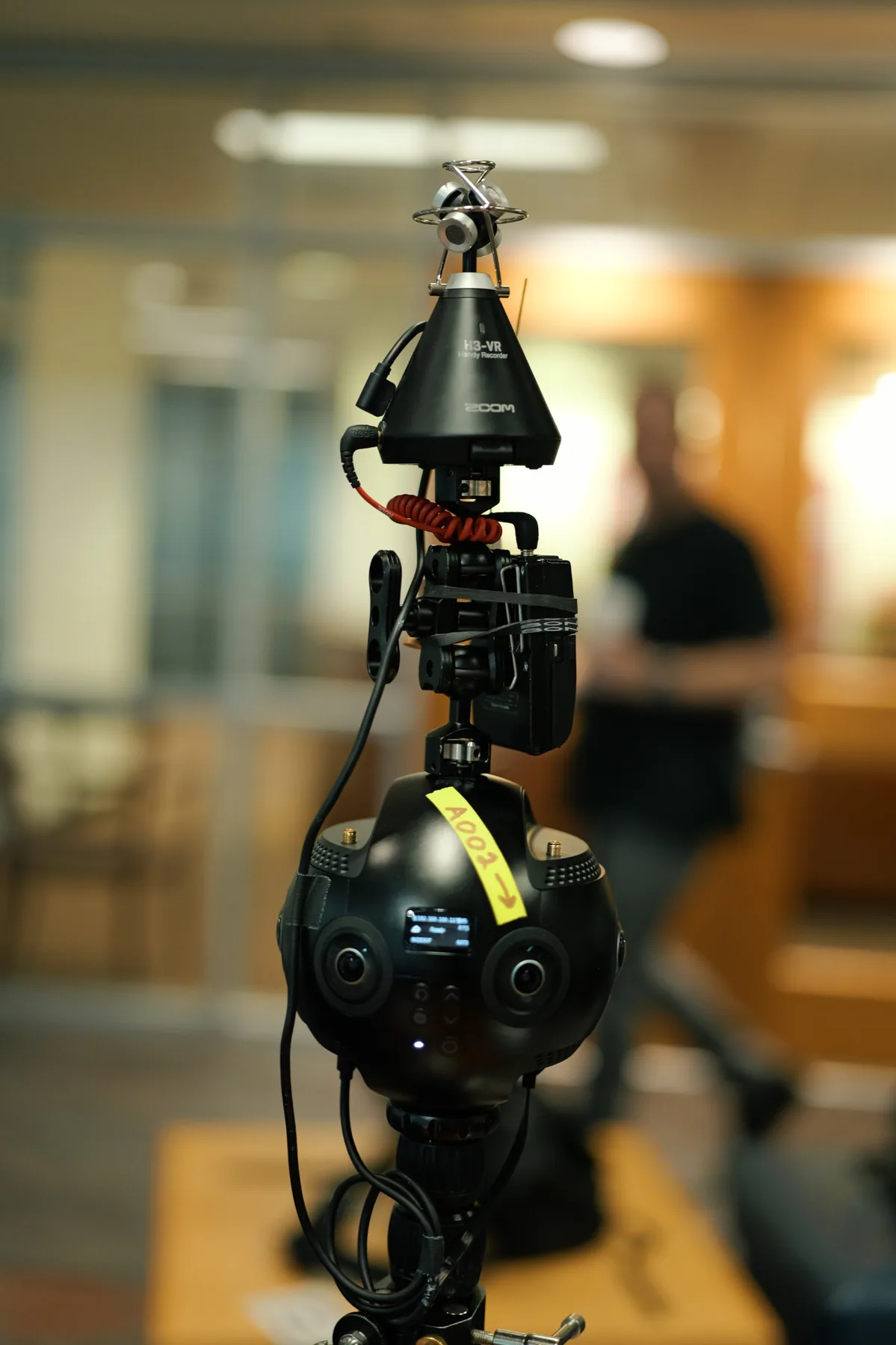 Close-up of a 360-degree video camera and spatial audio recorder on set.