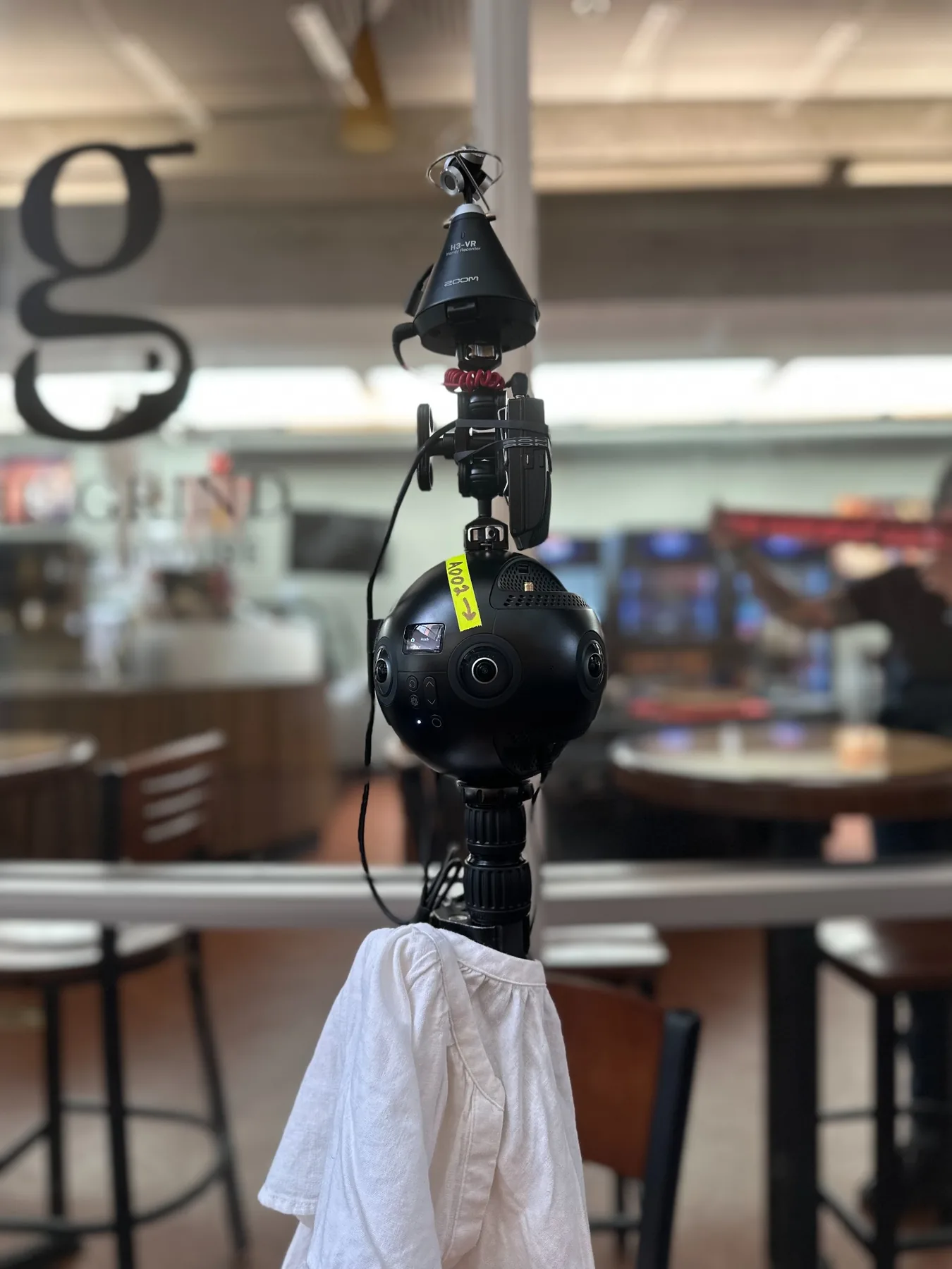 Interactive VR production setup with 360-degree camera equipment in a real-world location.