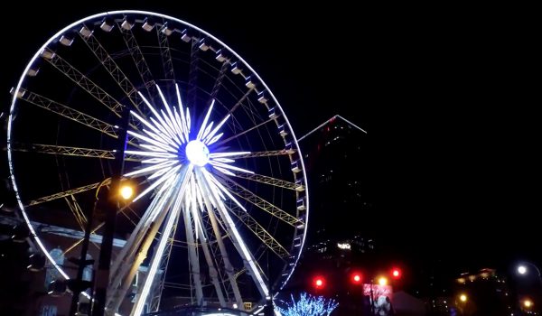 A ferris wheel shines bright against a night sky, symbolizing the importance of engineering in Georgia.