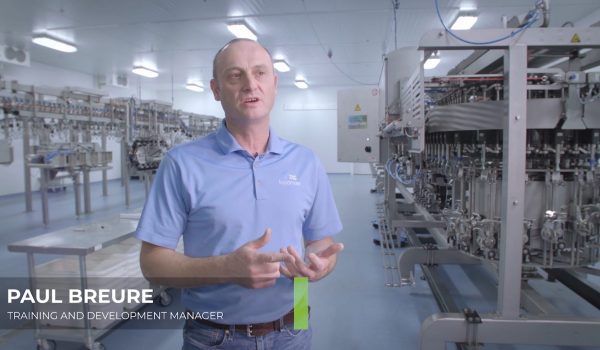 A man in a blue polo in a Foodmate production facility is filmed for a 2019 recruitment video.
