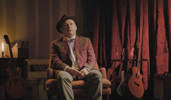 A man is interviewed for James Patterson's John Lennon biography, Last Days.