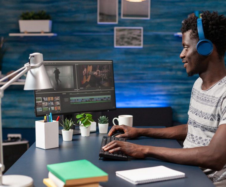 African american videographer editing video montage for visual effects movie project on computer. Filmmaker editor working remote from home at footage using digital post production software