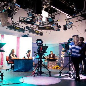 A crew on a TV stage films promotional videos