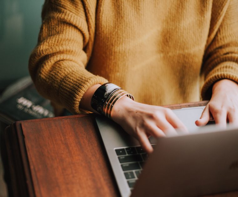 woman types on laptop