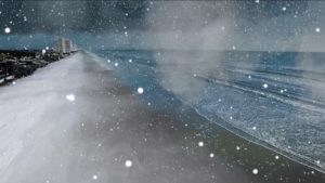 Snow falls on a Florida coastline indicating that winter is coming.